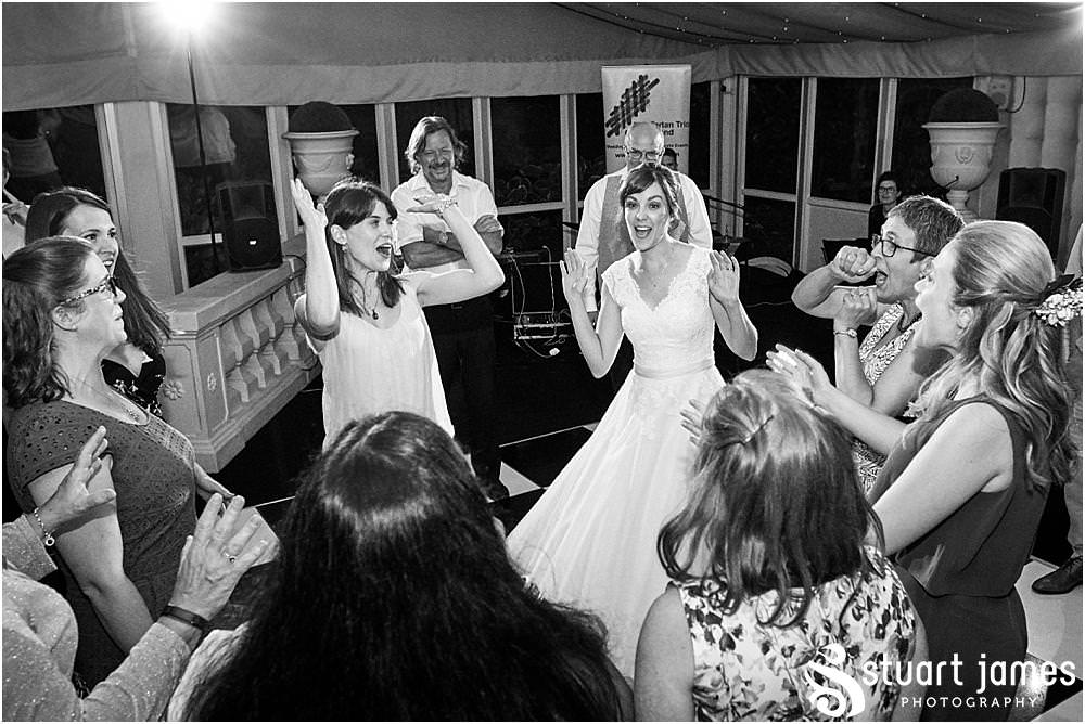 Capturing the fun of the reception as the guests love the ceilidh in the marquee at Moxhull Hall in Sutton Coldfield by Moxhull Hall Wedding Photographer Stuart James