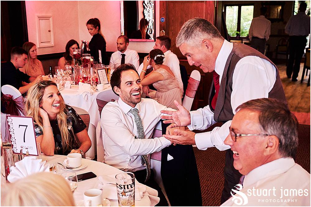 Creative candid photographs as the guests enjoy the wedding breakfast at The Moat House by Stafford Wedding Photographers Stuart James