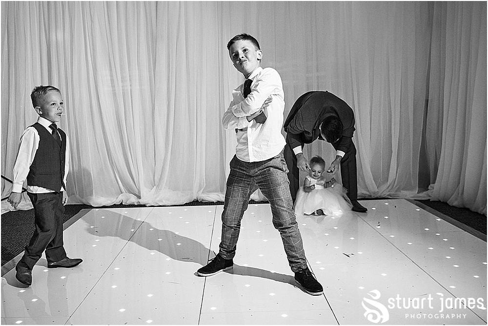 Relaxed reportage photographs capture the guests enjoying the start of the evening reception at The Moat House by Stafford Wedding Photographers Stuart James