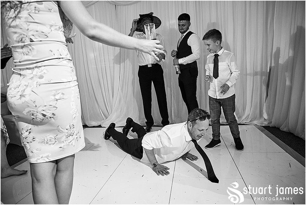 Relaxed reportage photographs capture the guests enjoying the start of the evening reception at The Moat House by Stafford Wedding Photographers Stuart James