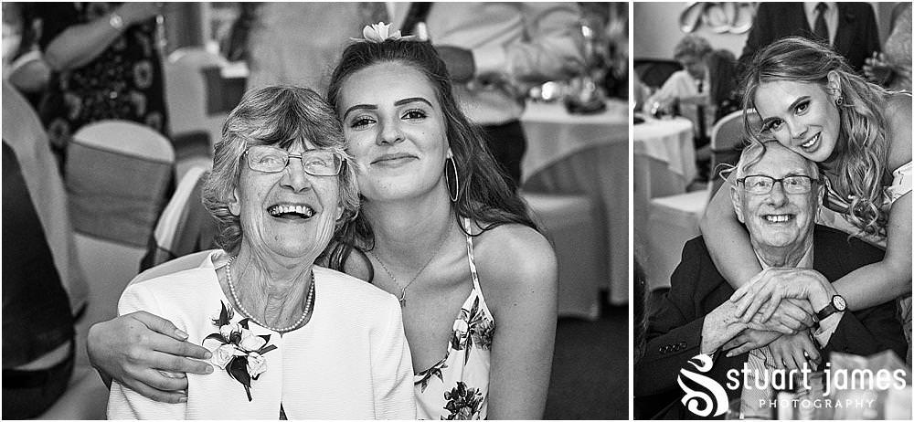 Relaxed reportage photographs capture the guests enjoying the start of the evening reception at The Moat House by Stafford Wedding Photographers Stuart James