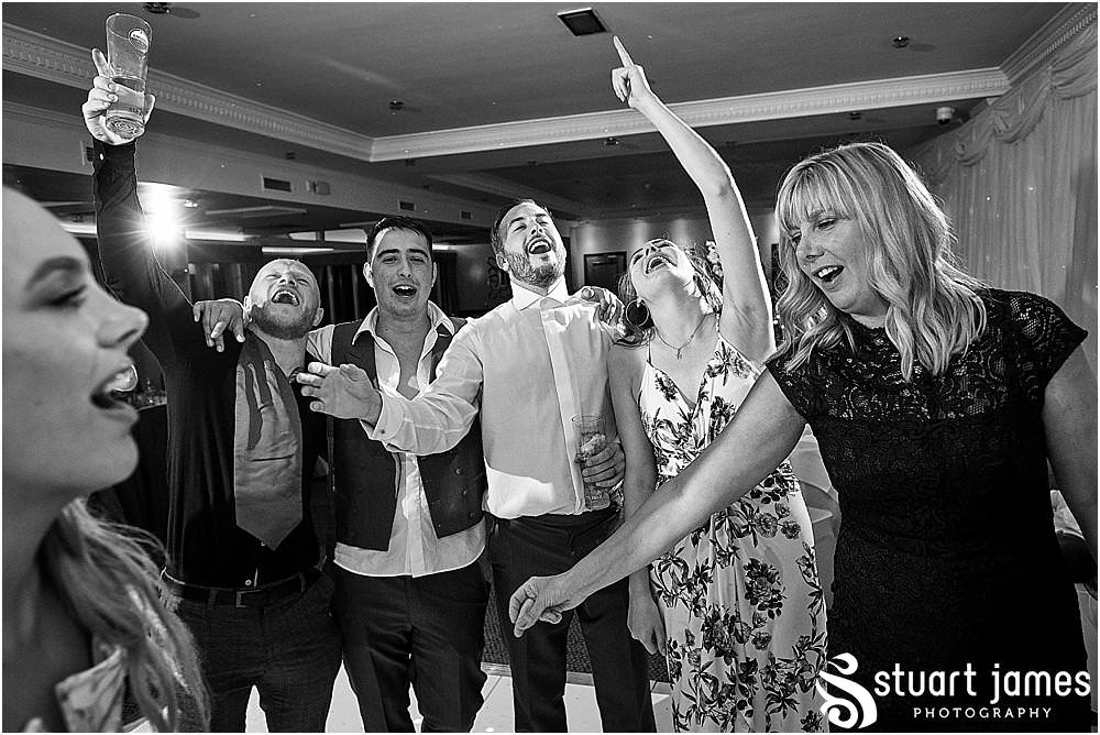 One wild and fun party with photographs capturing the real spirit and excitement of the wedding at The Moat House by Stafford Wedding Photographers Stuart James