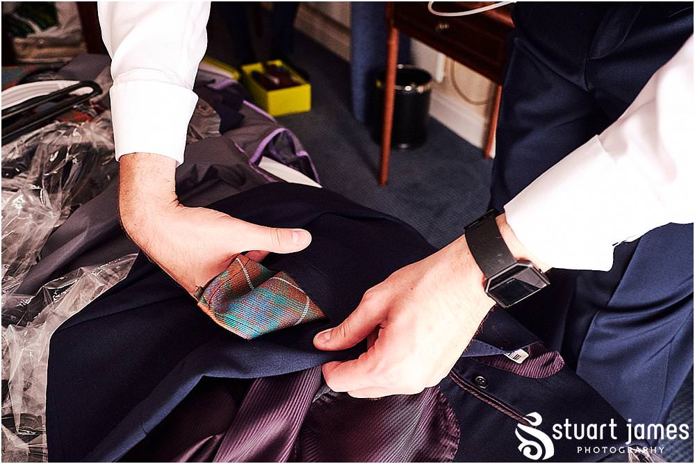 Such exciting moments as the details all come together during the preparations of the groom and best men at Windmill Village in Coventry by Windmill Village Wedding Photographer Stuart James