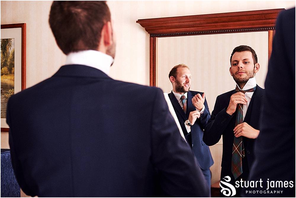 Such exciting moments as the details all come together during the preparations of the groom and best men at Windmill Village in Coventry by Windmill Village Wedding Photographer Stuart James
