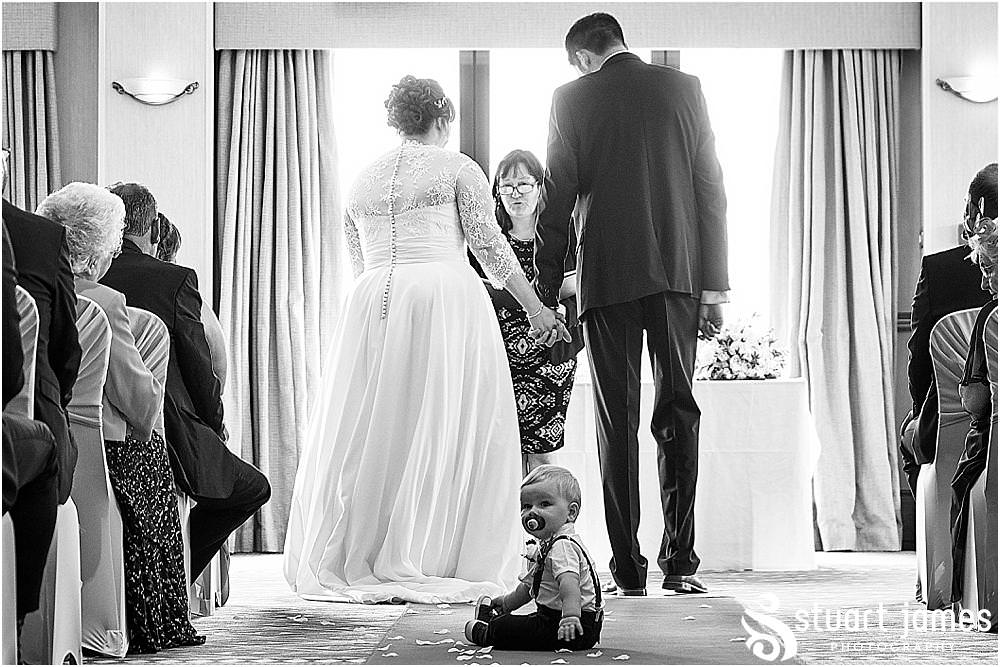 Such beautiful moments as the bride and groom's son relaxes during the ceremony at Windmill Village in Coventry by Windmill Village Wedding Photographer Stuart James