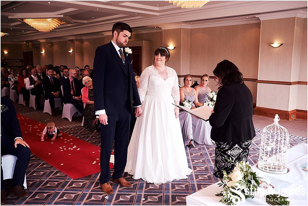 Capturing the looks and little moments that bring the memories of the wedding ceremony back to life at Windmill Village in Coventry by Windmill Village Wedding Photographer Stuart James