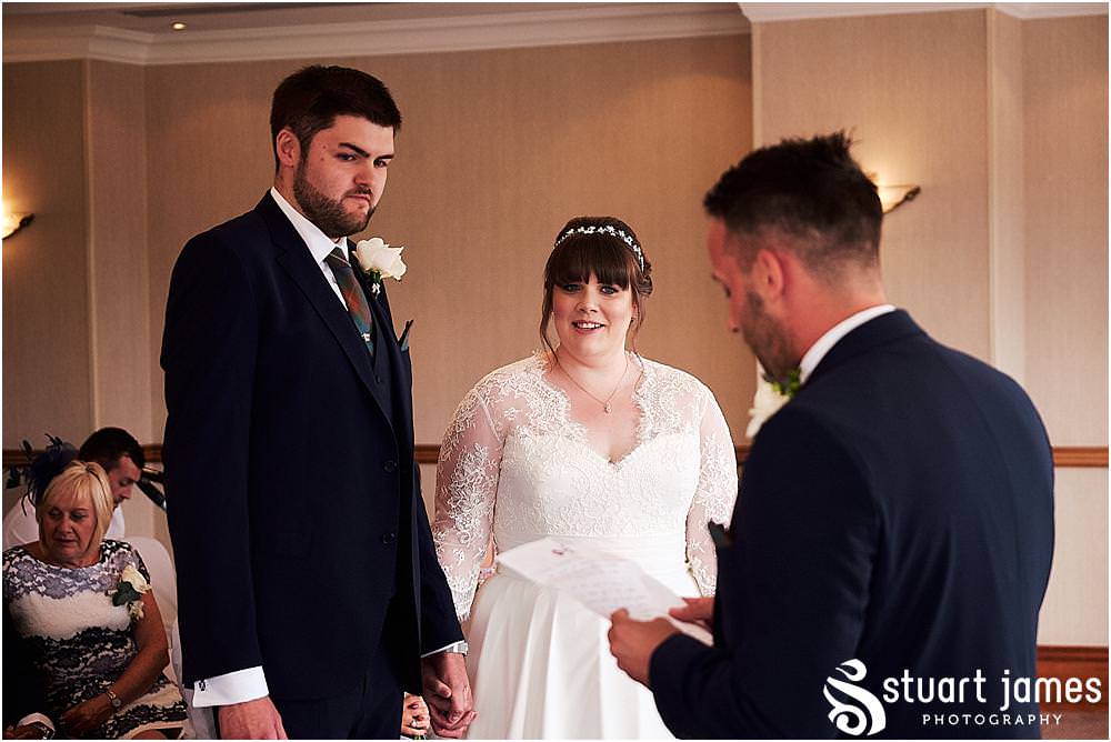 Capturing the looks and little moments that bring the memories of the wedding ceremony back to life at Windmill Village in Coventry by Windmill Village Wedding Photographer Stuart James