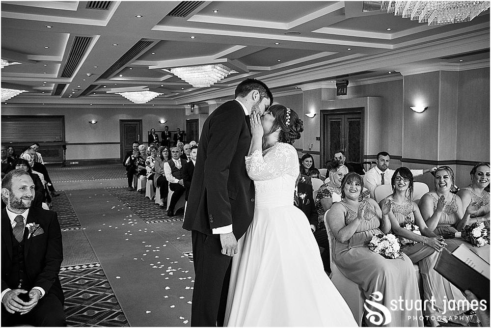 Capturing the looks and little moments that bring the memories of the wedding ceremony back to life at Windmill Village in Coventry by Windmill Village Wedding Photographer Stuart James