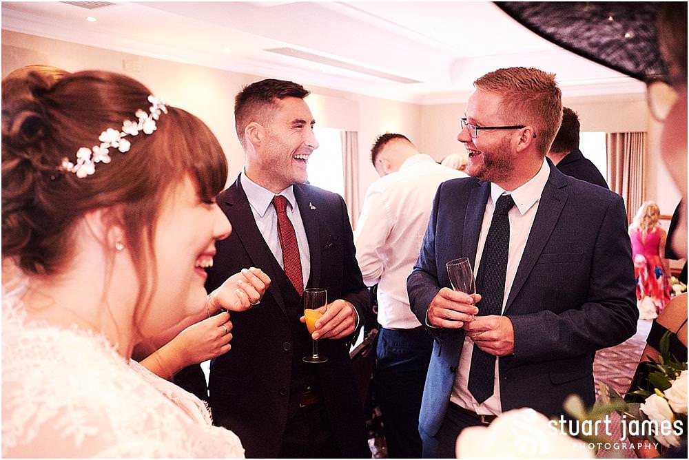 Candid photographs of the guests enjoying the drinks reception at Windmill Village in Coventry by Windmill Village Wedding Photographer Stuart James