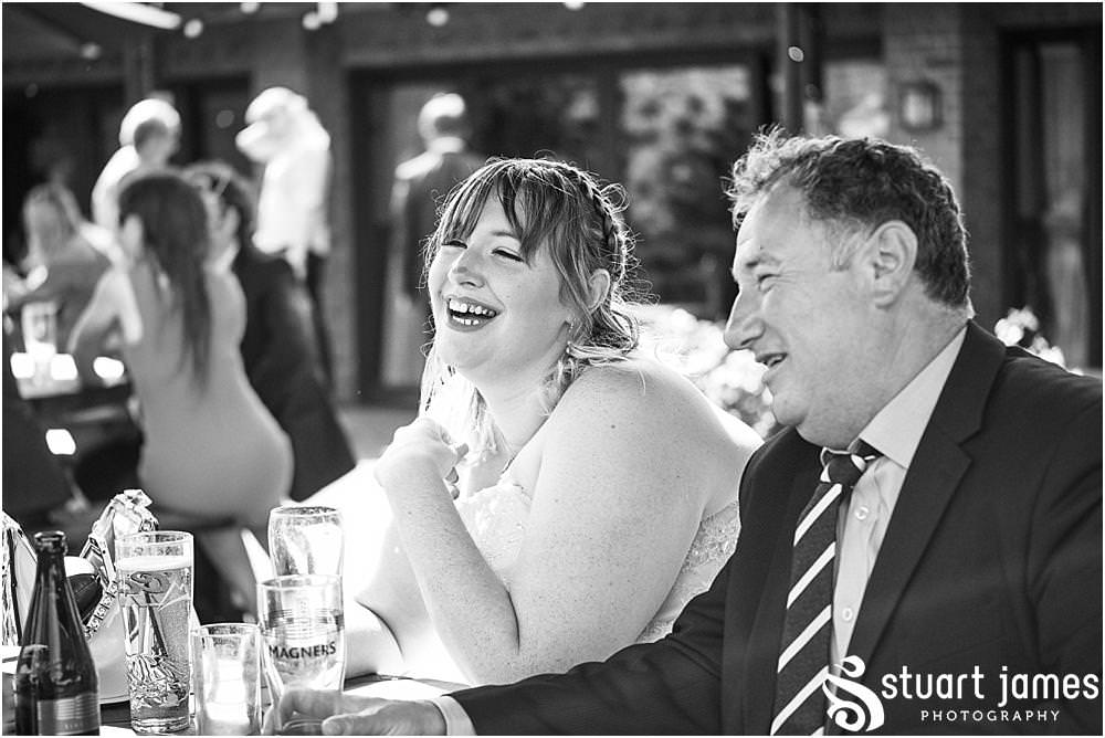 Candid photos of the guests enjoying the wedding reception in the garden at Oak Farm Hotel in Cannock - Oak Farm Wedding Photographs by Stuart James