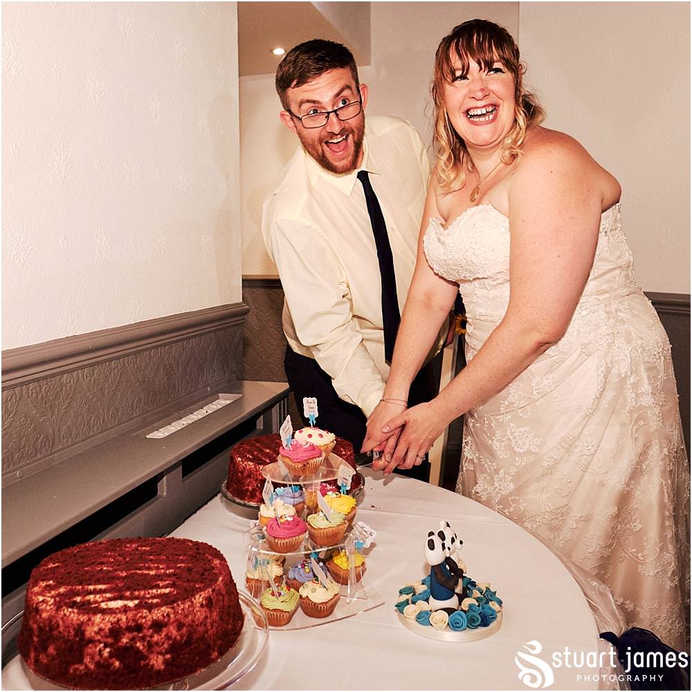 Cake cutting fun at Oak Farm Hotel in Cannock - Oak Farm Wedding Photographs by Stuart James