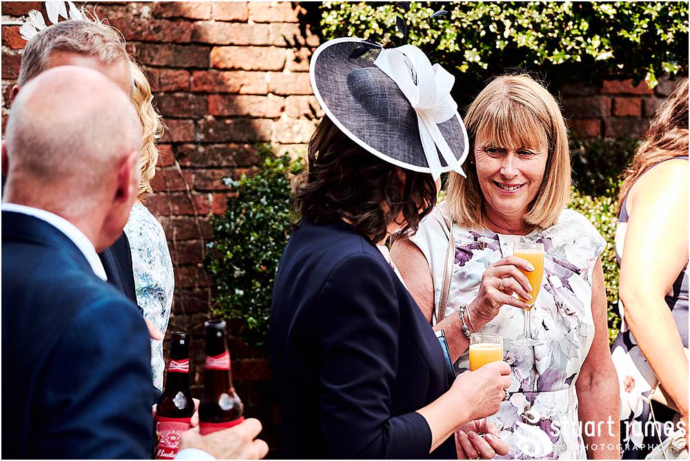 Creative candid photographs as the guests enjoy the fabulous reception in the gardens at Blakelands in Stourbridge by Documentary Wedding Photographer Stuart James