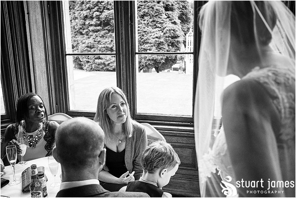 Creative candid photographs as the guests enjoy the drinks reception sheltering from the rain at Hawkesyard Estate - Hawkesyard Wedding Photographs by Stuart James