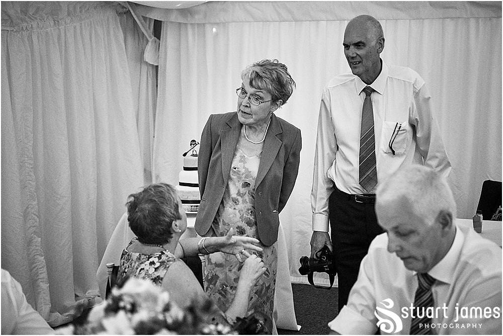 Candid photos as the guests enjoy the wedding reception at Heath House in Tean by Heath House Wedding Photographers Stuart James