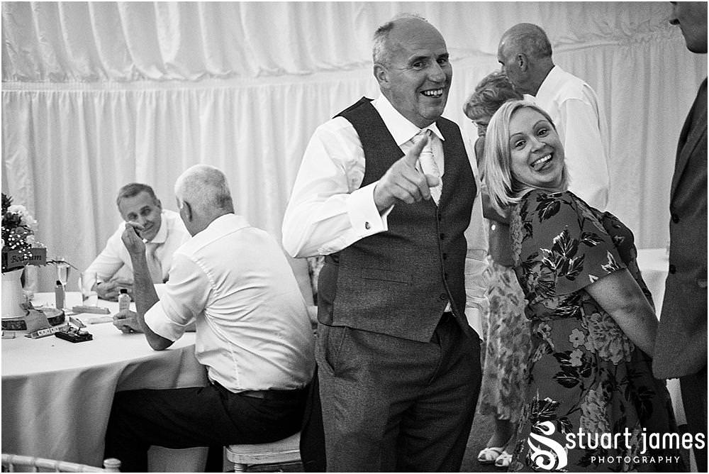 Candid photos as the guests enjoy the wedding reception at Heath House in Tean by Heath House Wedding Photographers Stuart James