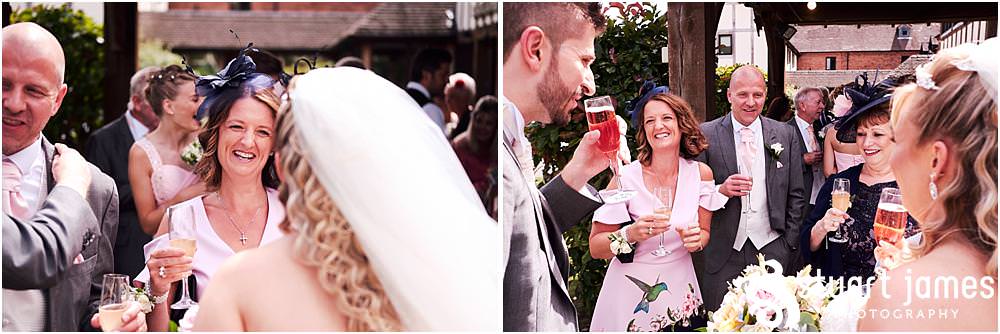 Creative candid photos of the guests greeting the new Mr & Mrs at The Moat House in Acton Trussell - Recommended Stafford Wedding Photographers Stuart James