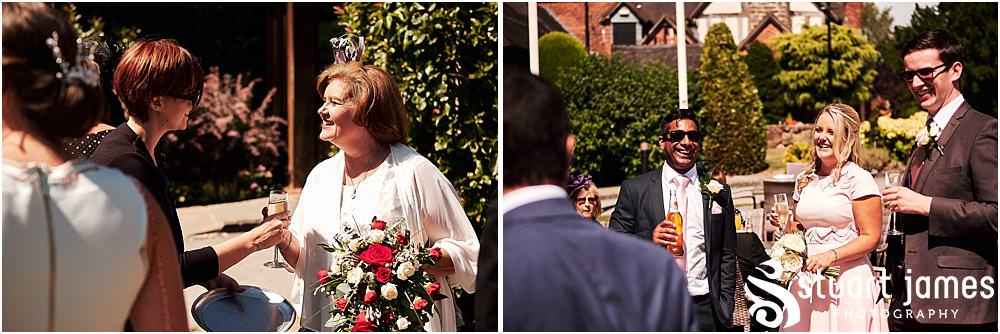 Creative candid photographs of the guests greeting the new Mr & Mrs at Stafford Registry Office in Stafford by Stafford Registry Office Wedding Photographers Stuart James