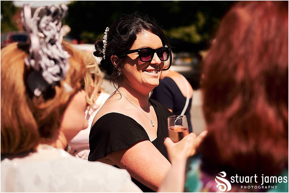 Creative candid photographs of the guests greeting the new Mr & Mrs at Stafford Registry Office in Stafford by Stafford Registry Office Wedding Photographers Stuart James