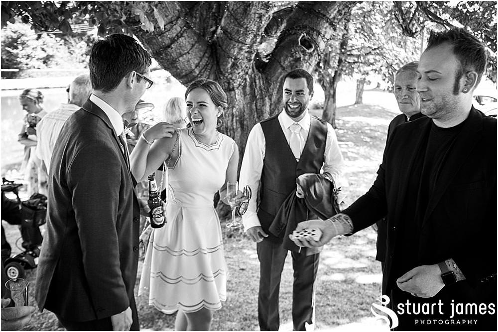 Capturing the reactions of the guests to the close up magician at The Moat House in Stafford - Stafford Registry Office Wedding Photographers Stuart James