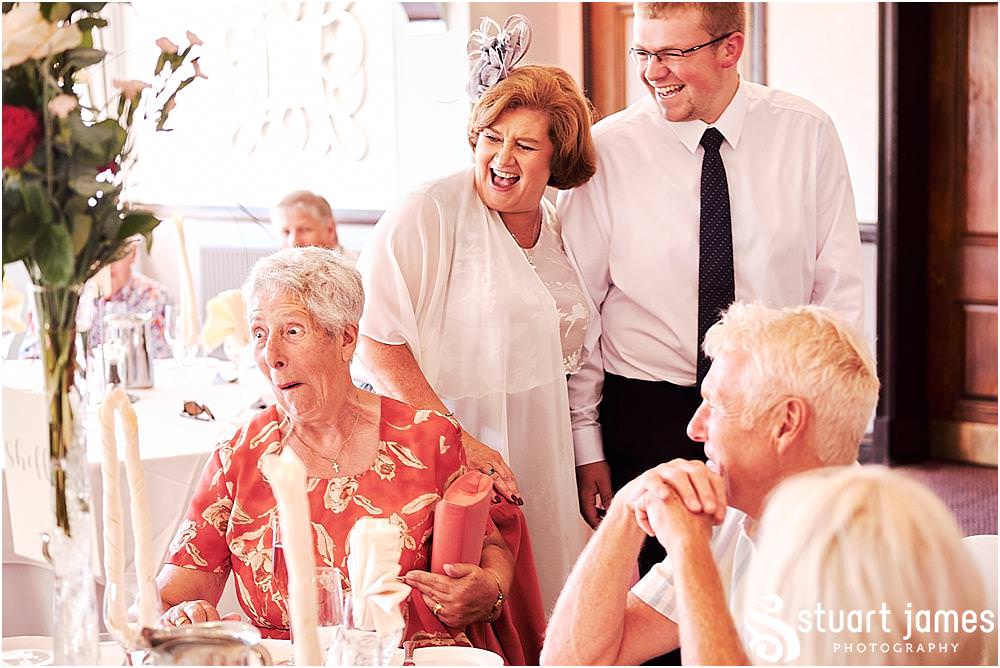 Creative candid photographs as the guests enjoy the wedding breakfast in the acton suite at The Moat House in Stafford - Stafford Registry Office Wedding Photographers Stuart James