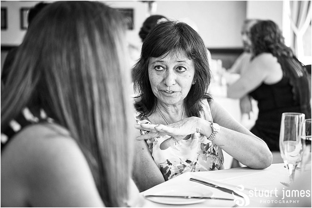 Creative candid photographs as the guests enjoy the wedding breakfast in the acton suite at The Moat House in Stafford - Stafford Registry Office Wedding Photographers Stuart James
