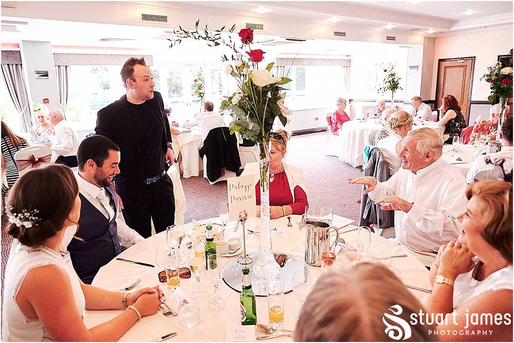 Creative candid photographs as the guests enjoy the wedding breakfast in the acton suite at The Moat House in Stafford - Stafford Registry Office Wedding Photographers Stuart James
