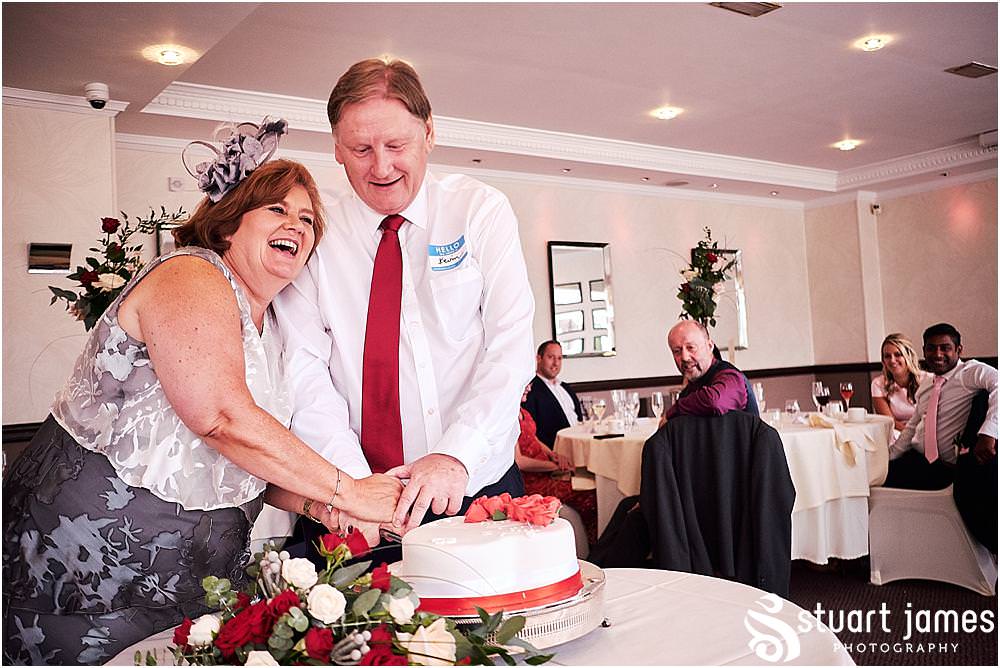 Cake cutting fun at The Moat House in Stafford - Stafford Registry Office Wedding Photographers Stuart James