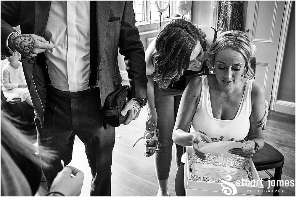 Emotional moments for the bride as she opens her gift from her groom at Pendrell Hall in Codsall Wood by Staffordshire Recommended Wedding Photographer Stuart James