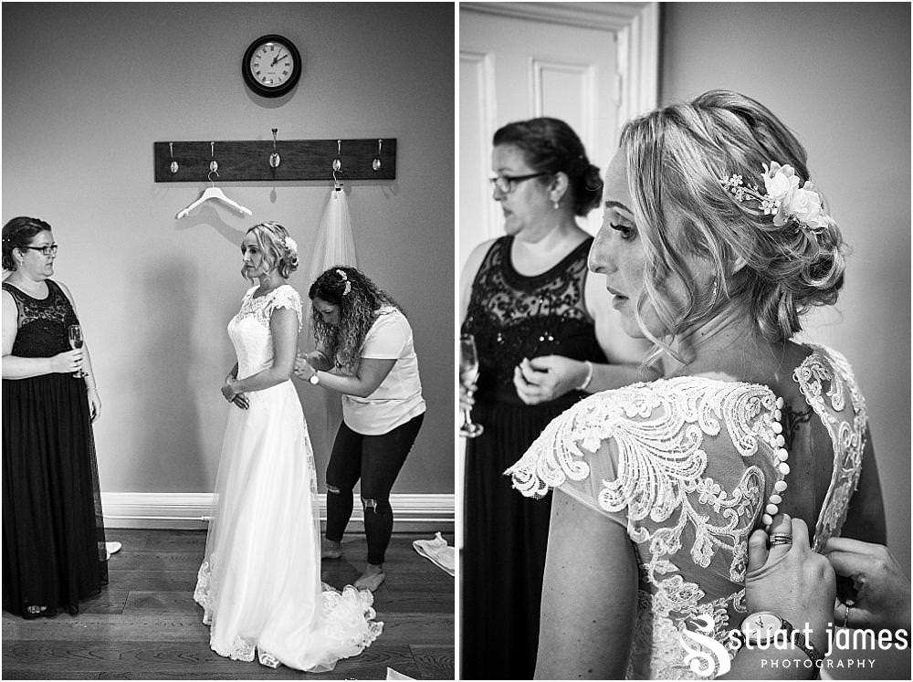 Final exciting moments as the bride dresses in her beautiful gown for the wedding at Pendrell Hall in Codsall Wood by Staffordshire Recommended Wedding Photographer Stuart James