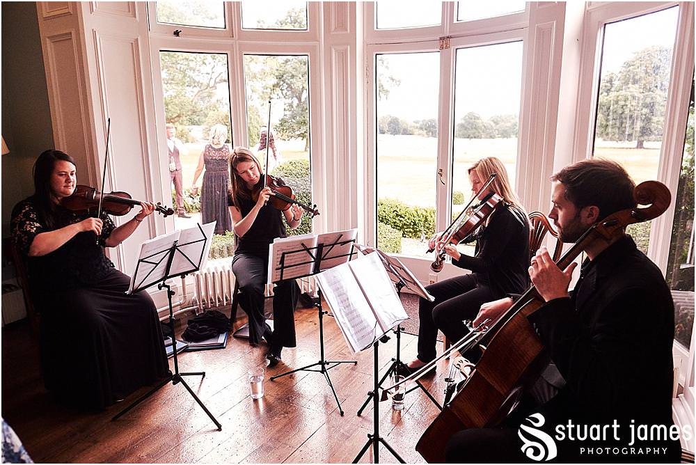 Creative candid photos of the guests enjoying the wedding reception at Pendrell Hall in Codsall Wood by Staffordshire Recommended Wedding Photographer Stuart James