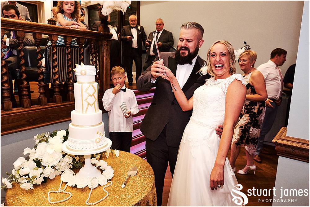 Cake cutting fun at Pendrell Hall in Codsall Wood by Staffordshire Recommended Wedding Photographer Stuart James