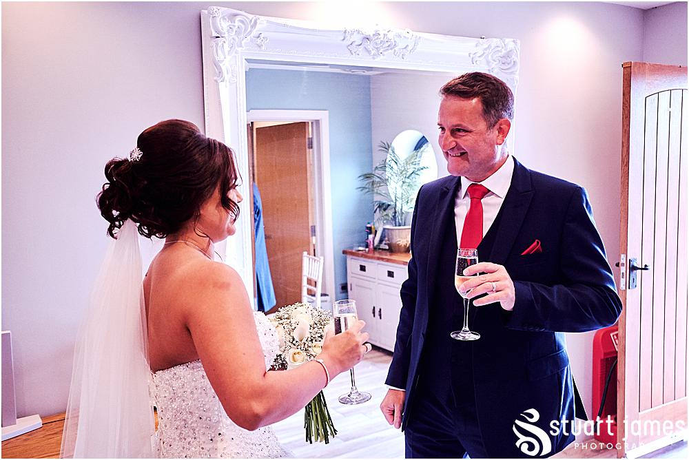Father of the bride and bride toast with glasses before going to the church, photo by Stuart James Photography at Aston Marina, Stone