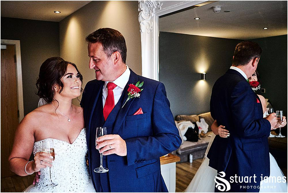 Father of the bride and bride look lovingly at each other in front of a mirror, photo by Stuart James Photography at Aston Marina, Stone