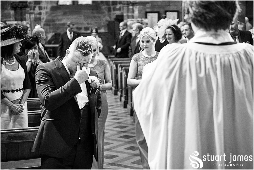 Groom gets emotional at altar as bridesmaids walk up aisle followed by bride, photo by Stuart James Photography at Holy Trinity, Eccleshall