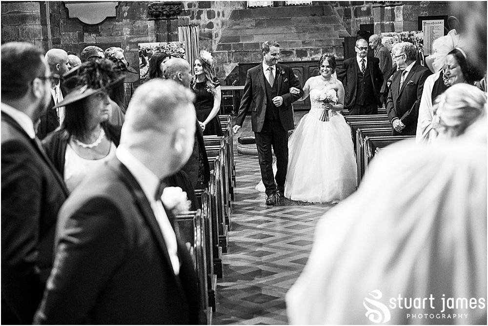 Groom gets emotional watching Bride walk up aisle arm in arm with Father of the Bride, photo by Stuart James Photography at Holy Trinity, Eccleshall