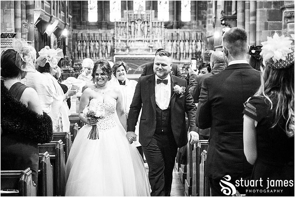 Bride and Groom leave the church holding hands and walking down the aisle, photo by Stuart James Photography at Holy Trinity, Eccleshall