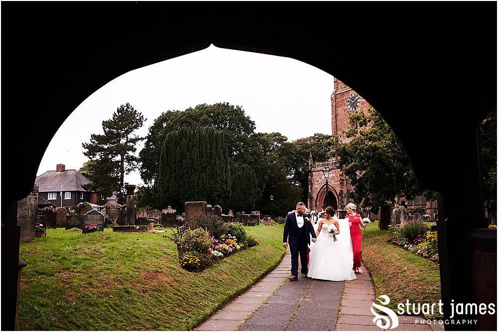 Bride, Groom and wedding guests leaving the church, photo by Stuart James Photography at Holy Trinity, Eccleshall