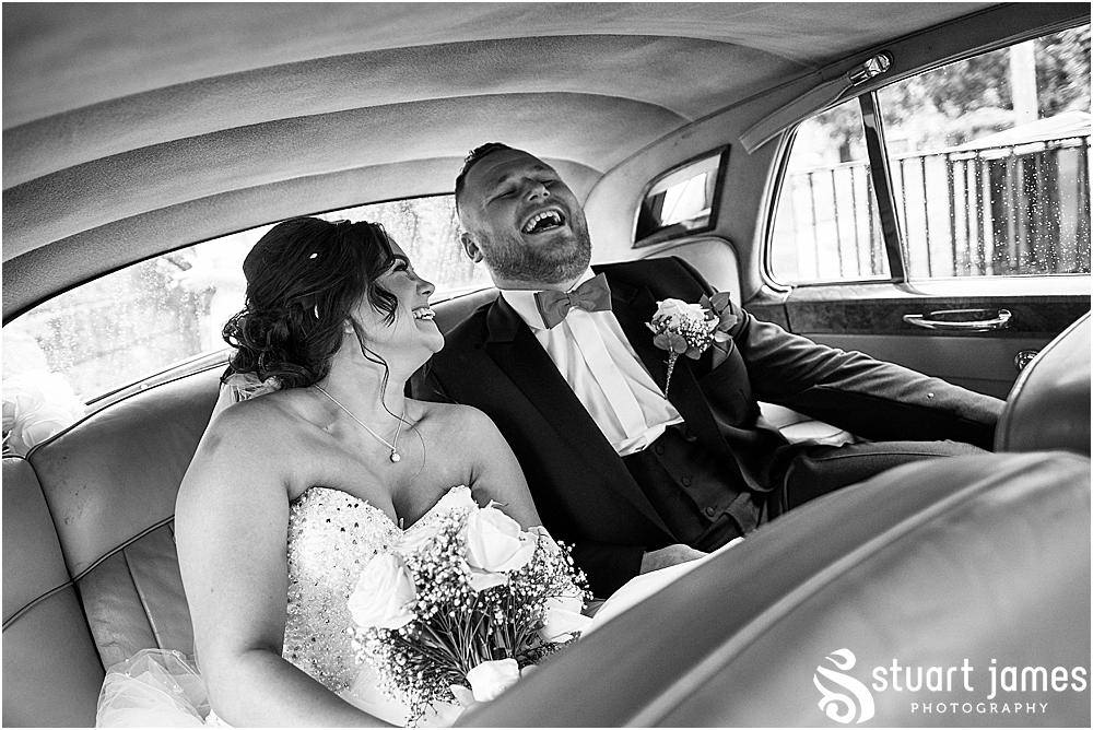 Bride and Groom sat in the back of the wedding car laughing, to go their wedding reception as Aston Marina, photo by Stuart James Photography at Holy Trinity, Eccleshall
