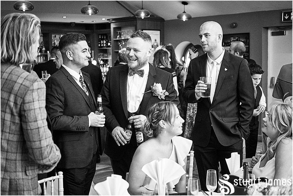Wedding guests laugh with Groom and sit at table, photo by Stuart James Photography at Aston Marina, Stone.