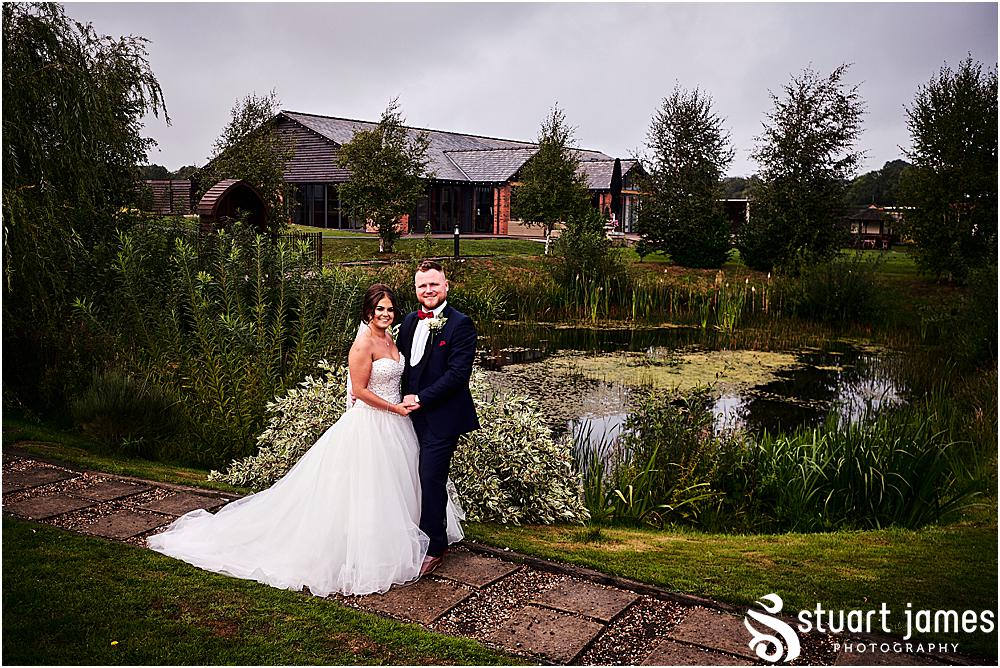 Bride and Groom pose outside by pond for wedding photograph, photo by Stuart James Photography at Aston Marina, Stone