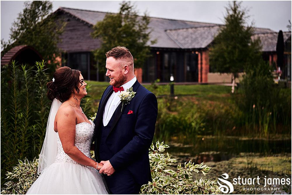Bride and Groom pose outside by pond for wedding photograph, photo by Stuart James Photography at Aston Marina, Stone