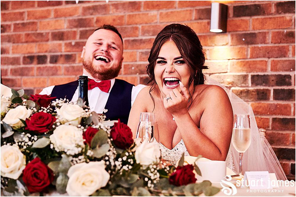 Bride and Groom laugh at fathers of the brides speech at the top table, photo by Stuart James Photography at Aston Marina, Stone.