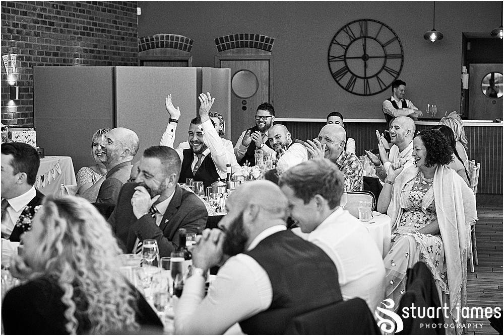 Wedding guests laughing at best man's speech, photo by Stuart James Photography at Aston Marina, Stone
