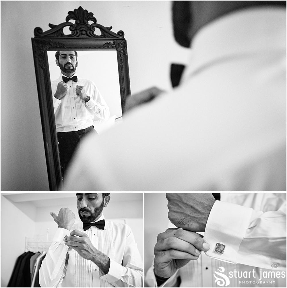 Groom adjusts bow tie and put in his cufflinks at Davenport House in Shropshire by Davenport House Wedding Photographers Stuart James