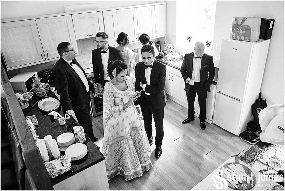 Wedding party wait in kitchen for Birde and Groom to get ready at Davenport House in Shropshire by Davenport House Wedding Photographers Stuart James