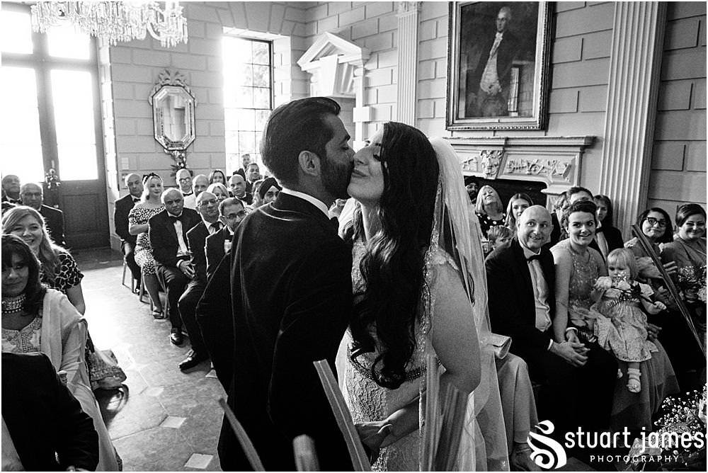 Bride and Groom kiss on the cheek after wedding vows at Davenport House in Shropshire by Davenport House Wedding Photographers Stuart James