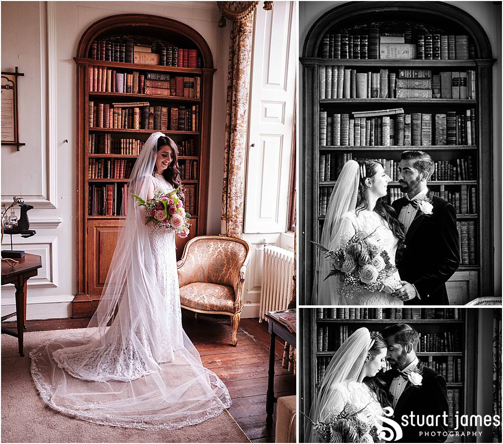 Bride and Groom pose for portraits by bay window and bookcase at Davenport House in Shropshire by Davenport House Wedding Photographers Stuart James