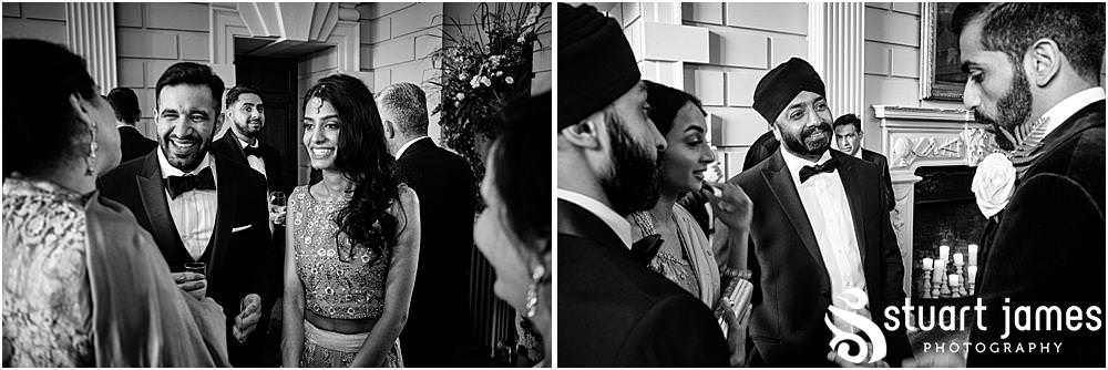 Wedding Guests and Groom talk at Davenport House in Shropshire by Davenport House Wedding Photographers Stuart James