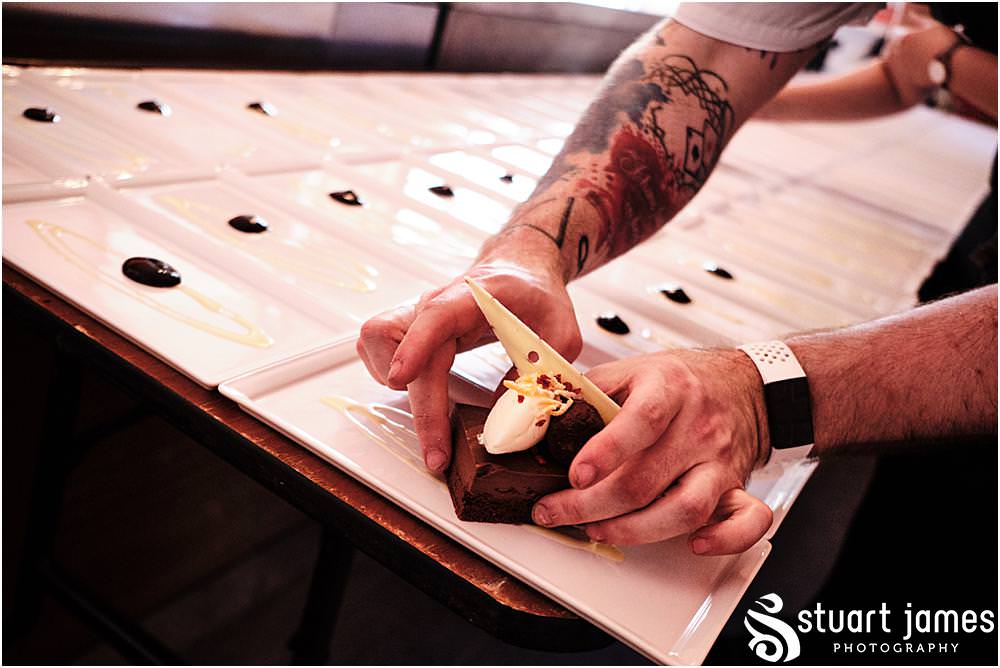 Chocolate wedding dessert being placed on a plate at Davenport House in Shropshire by Davenport House Wedding Photographers Stuart James