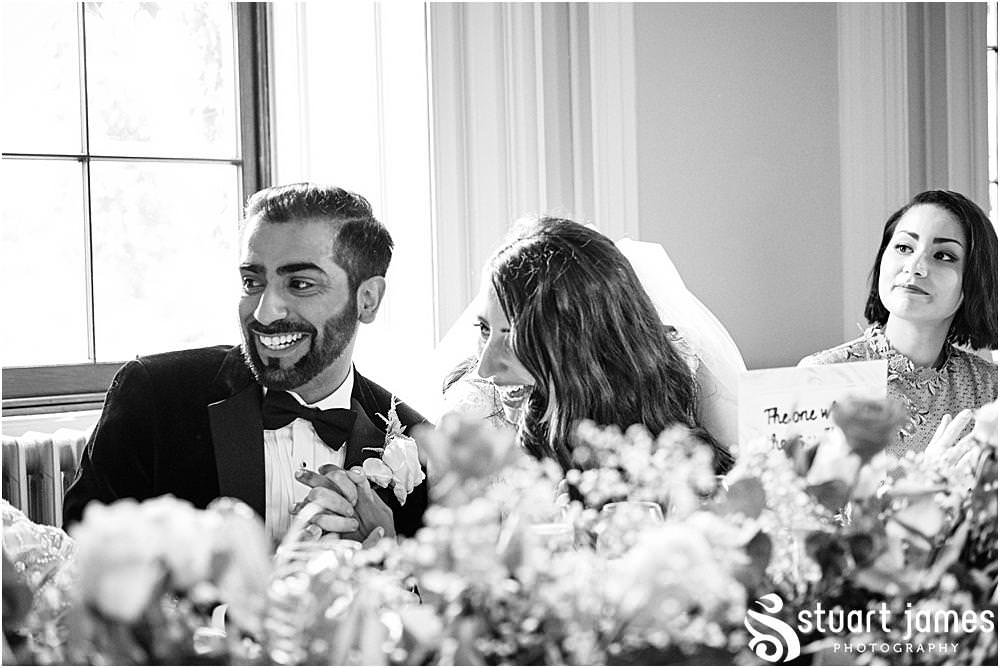 Bride and Groom laugh at top table at Davenport House in Shropshire by Davenport House Wedding Photographers Stuart James